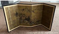 Screen fully opened showing full mountain landscape scene across four panels