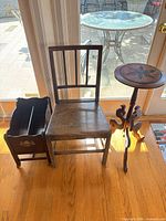 Overall view of magazine rack, oak chair, plant stand