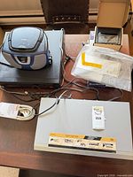 Group shot showing DVD player, VCR, boombox, audio converter box, extension cord