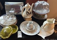 Group shot showing Bundt carrier, teapot, pitcher, platters, green dishes, cookie tin and wrap dispenser