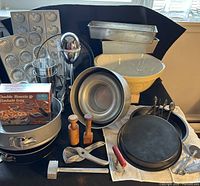 Group shot of mixer, ceramic bowl, assorted pans and utensils