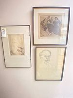Three framed artworks mounted on wall