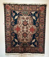 Full front view of hanging Persian-style wool rug showing overall design and fringe