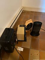 All heaters and cord reel grouped on floor