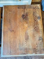 Top view of pine table showing grain, wear and protective glass