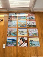 All 12 fabric wall hangings laid out on wooden wall