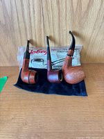Three briar pipes with Jobey bag and pipe cleaners pack