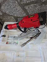 Demolition hammer with accessories on foam insert