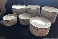 Stacks of assorted diameter white plates