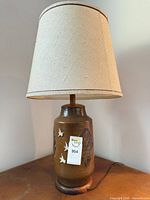 Full view of ceramic lamp with shade