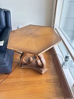 Full view of Tomlinson Pavane hexagonal side table beside sofa