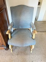 Front view of blue upholstered armchair showing overall design
