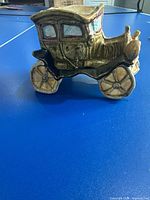 Left side view of ceramic car planter showing wheels, body and window detail