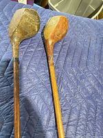 Two wooden golf drivers, heads visible