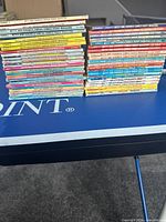 Two tall stacks of Betty and Veronica digest comics on a blue table