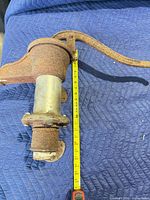 Full pump on padded surface with tape measure showing length