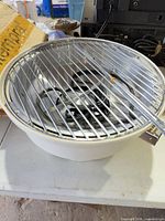 Top view of grill showing grate heating element inside white base