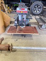 Front view of Sears Craftsman 10" radial arm saw with wooden table and metal stand