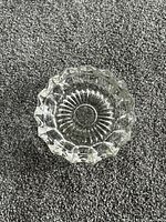 Top view of pressed crystal dish showing starburst pattern and scalloped rim