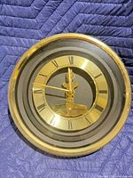 Front view of Daniel Dakota gold and black wall clock