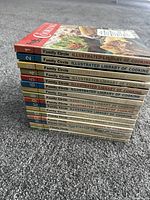 Stacked view of all 16 volumes showing numbered spines 1-16