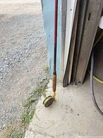 Fly rod butt section with reel and cork grip resting on floor