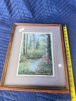 Full view of framed print with tape for height reference