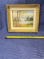 Front view of framed painting with measuring tape