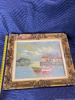 full view of painting with ornate frame and tape measure for scale