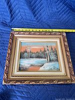 Front view showing painting, frame, and tape measure for scale
