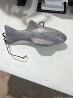 Left profile of fish-shaped lead sinker showing rear wire clip