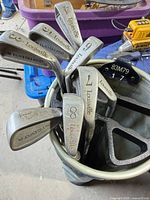 Top-down view showing multiple Louisville iron heads with numbers 6,8,9,10 and steel shafts inside bag