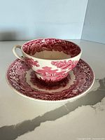side view of teacup resting on saucer showing full pattern