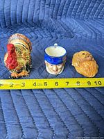 Front view of three Occupied Japan pieces with measuring tape