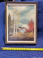 Front view of framed oil painting with measuring tape showing width ~12 in