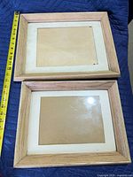 Front view of both light oak frames showing mats and glass