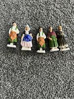 Front view of five porcelain figurines
