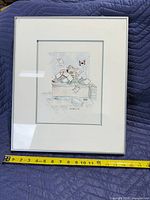 Front view of framed ink and watercolor drawing with measuring tape showing width