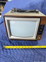 Front view of RCA ColorTrak portable CRT TV with screen and tape measure