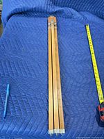 Easel folded beside tape measure and pen for scale