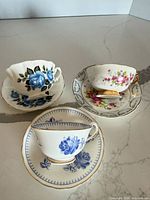 Three teacup and saucer pairs grouped