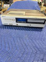 Front and top view of Sanyo VHS VCR showing controls and display
