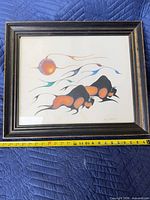 Front view of framed abstract buffalo print under glass with measuring tape showing size