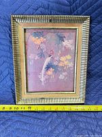 Front view of framed print with measuring tape for width