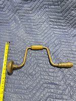 Top view of full hand brace drill with tape measure showing length