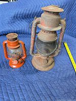 Beacon and orange lanterns side by side showing front view and size