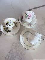 Three teacup and saucer sets displayed top view