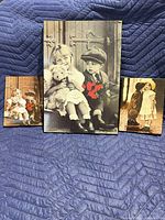 Front view of three sepia children photo plaques