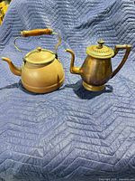 Front view of copper kettle and brass coffee pot