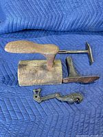 all four shoe repair tools on quilted pad